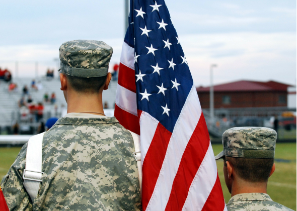 JROTC Cadets stand with the American Flag
